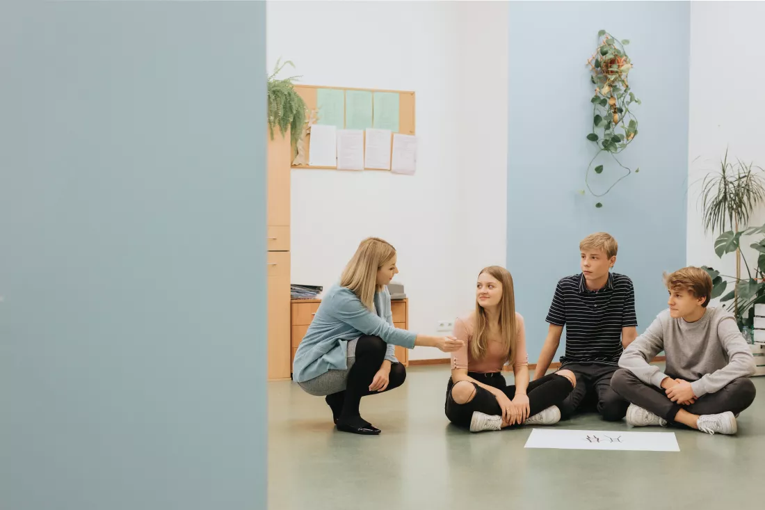 teenagers-sit-circle-floor-prepare-project-math-classes-together