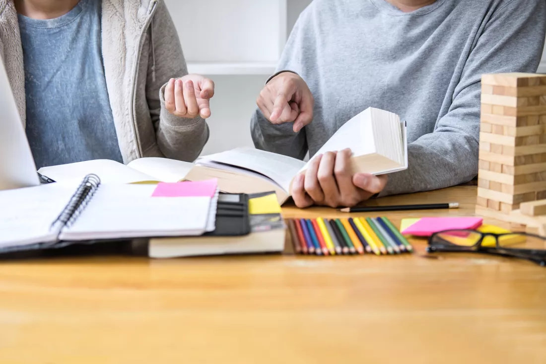midsection-couple-sitting-by-table