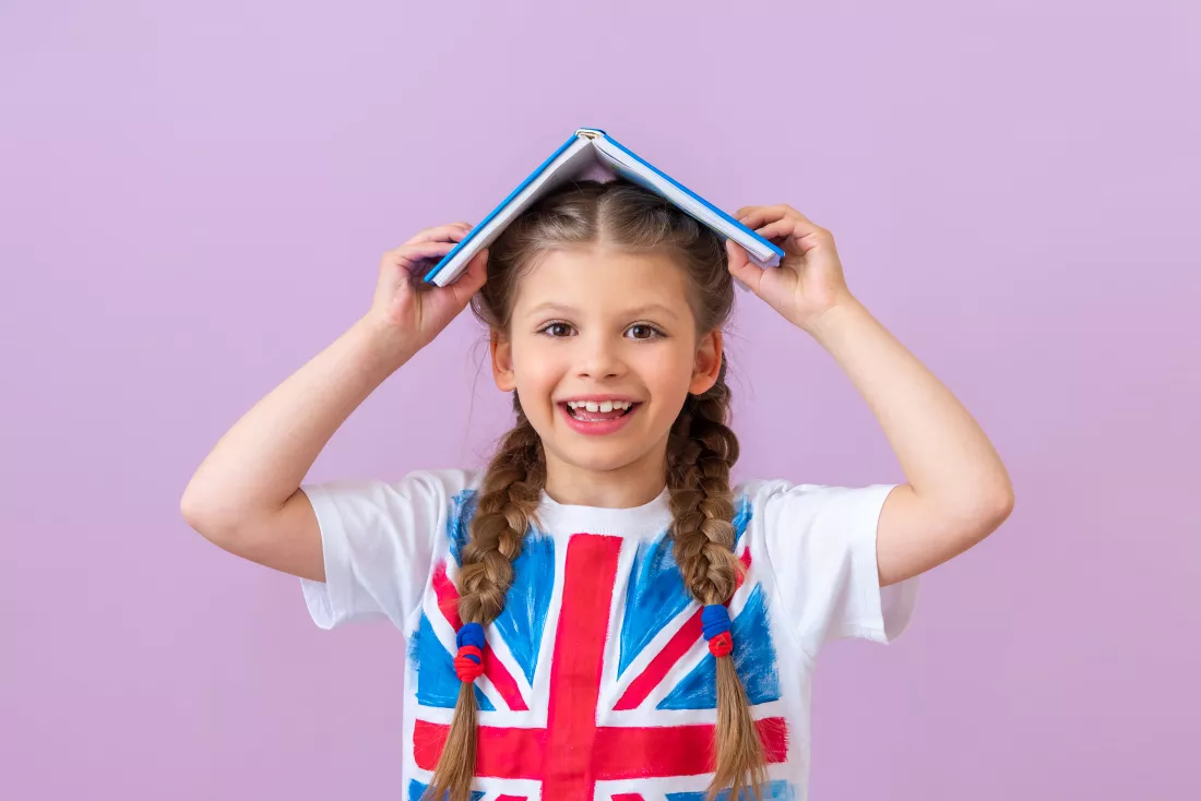 little-girl-with-english-flag-her-t-shirt-holds-book-her-head
